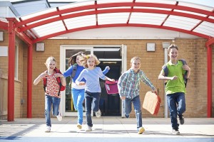 school children running and happy to leave school