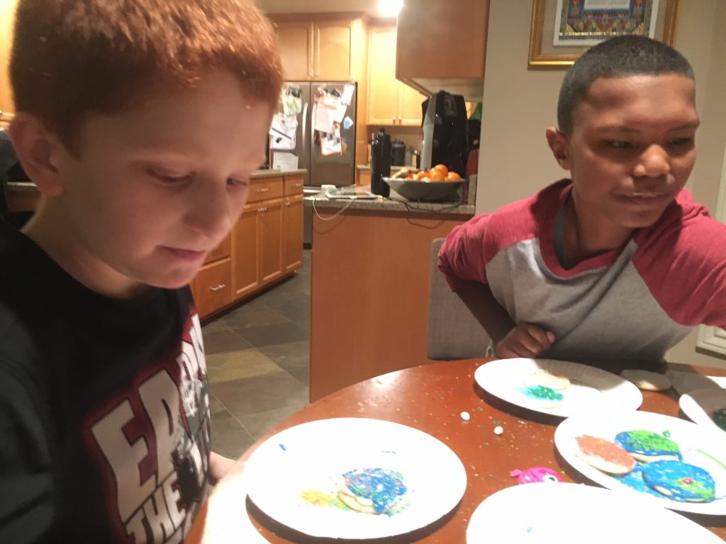 two boys decorating cookies