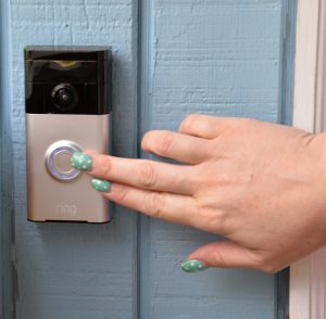 hand pressing a Ring doorbell