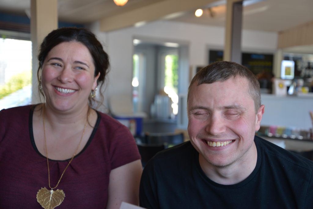 Krista and Michael laughing, inside coffee shop