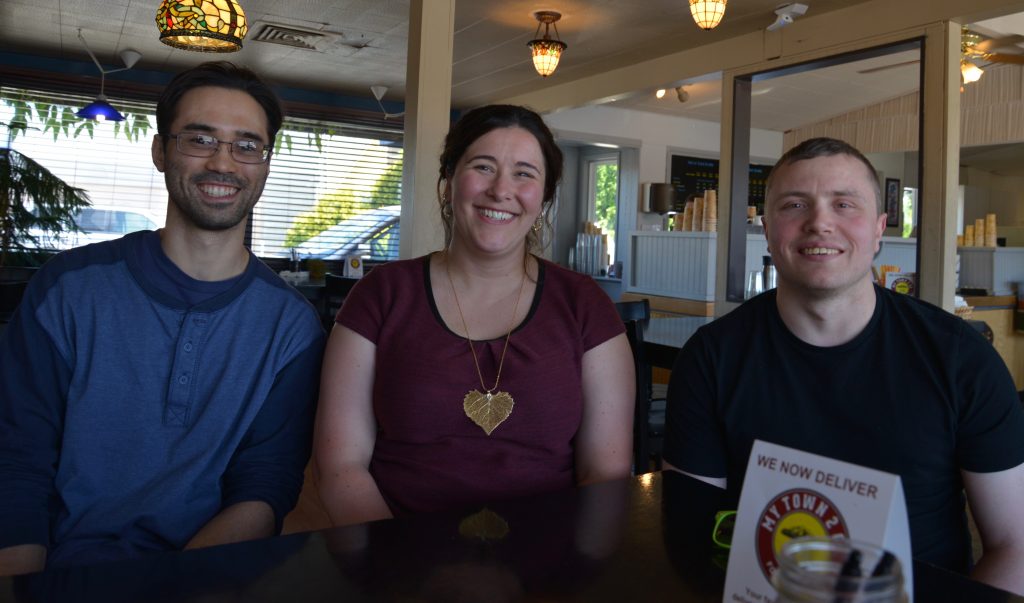 Ron, Krista, Michael in a coffee shop, smiling