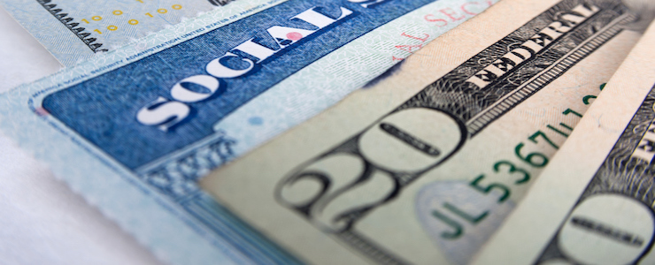 Social security card and American money dollar bills close up