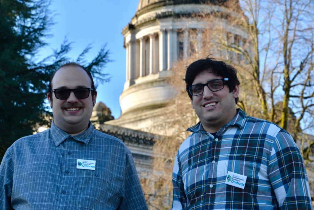 DD Ombuds staff, Tim McCue and Noah Seidel outside the state capitol building, smiling