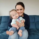 Whitney Stohr and her son sitting on sofa.