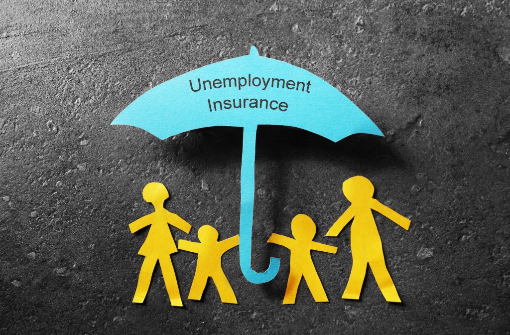 Paper cutout family of four under a blue Unemployment Insurance umbrella