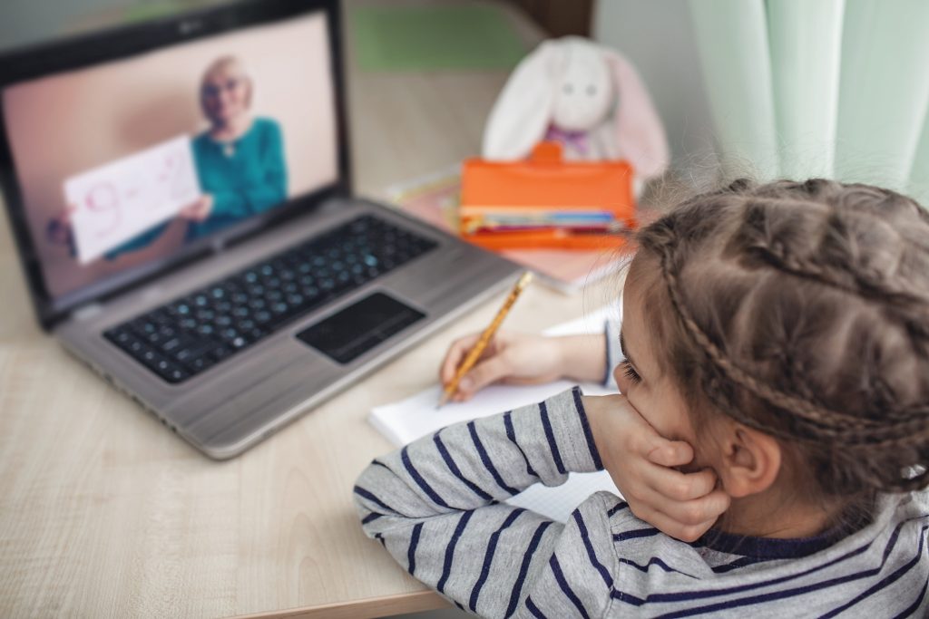  schoolgirl studying homework math during her online lesson at home, social distance during quarantine, self-isolation, online education concept.