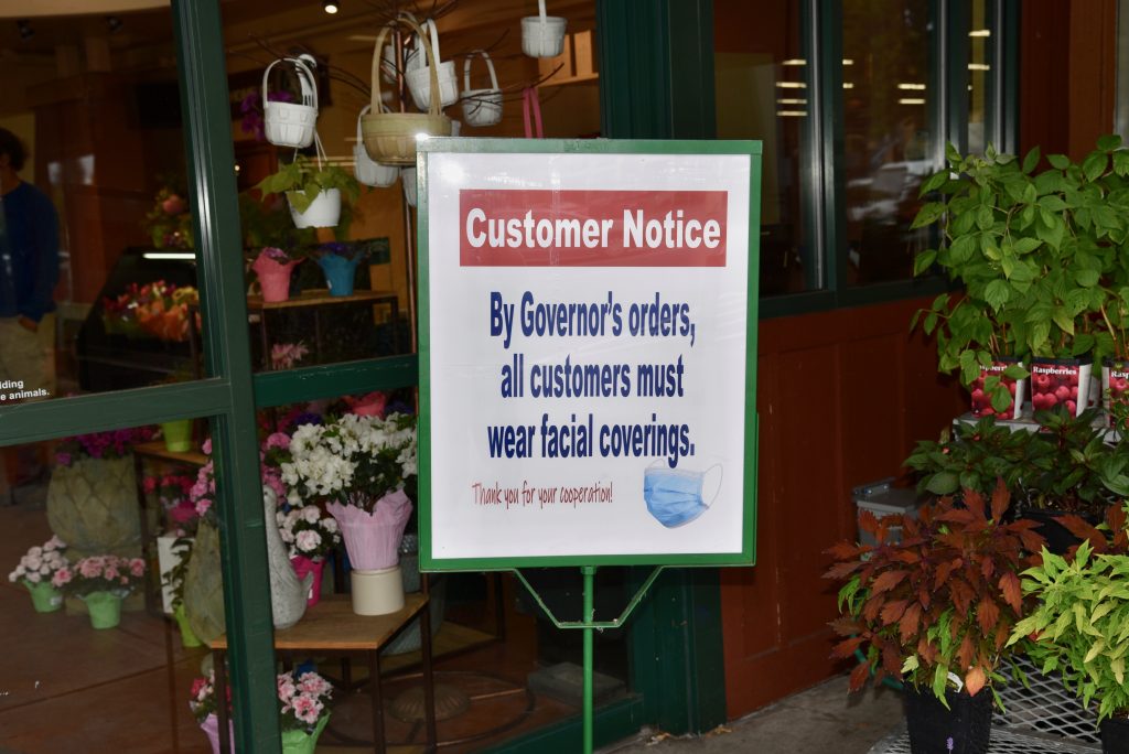 Notice of face covering requirement outside a grocery store.