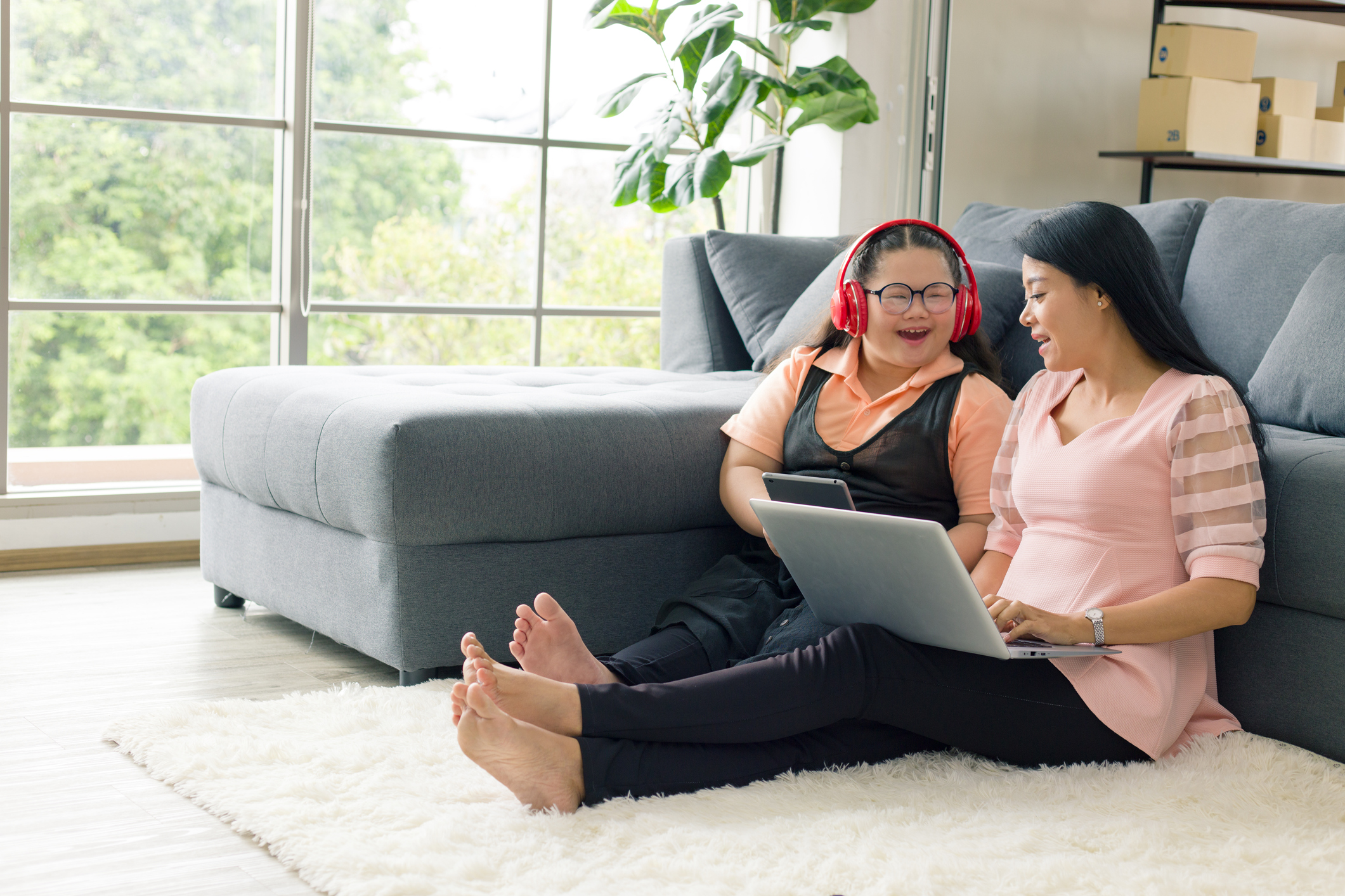 Mother and daughter at home on computer.